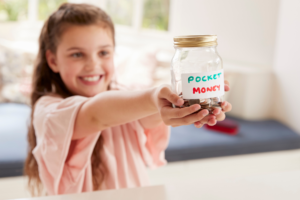 little girl donating pocket money